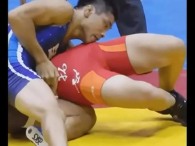 Young Japanese man has a sensual wrestling match with a big cock.