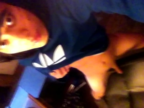 A young gay with a pretty face and emo hairstyle wearing a blue Adidas Trefoil Hoodie masturbates on a chair.
