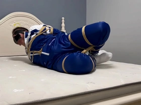 Gay bondage scene with an Asian boy in hogtie and blindfold