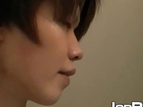 A young Japanese man masturbates with his buttocks spread open.