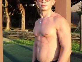 Enjoying the evening sunset while appreciating the beauty of muscle worship and big pecs in an Asian hunk.