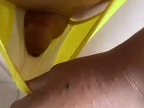 Solo guy shows off his small package in yellow satin panties