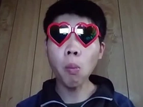 Young gay Japanese man masturbates on camera.